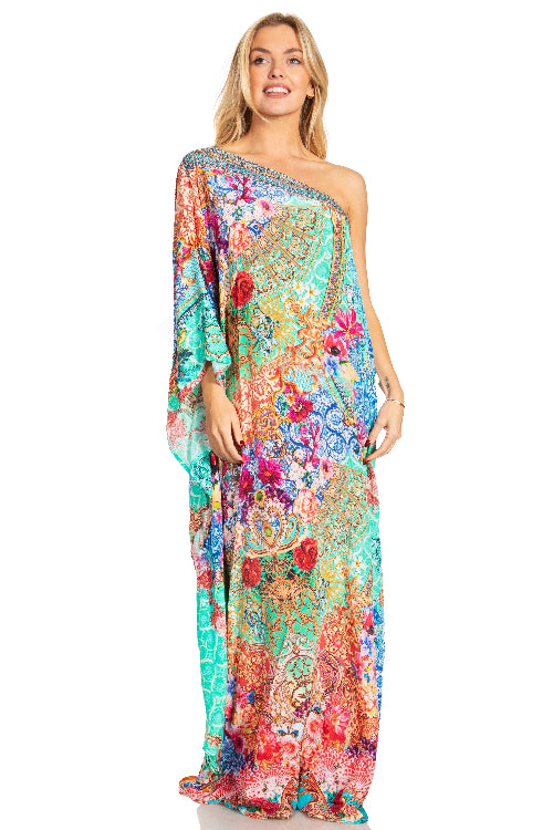 Woman wearing a colorful one-shoulder dress with a floral pattern on a white background