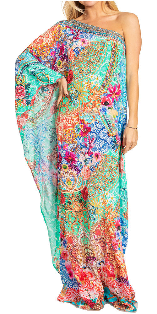 Woman wearing a colorful one-shoulder dress with floral patterns on a white background