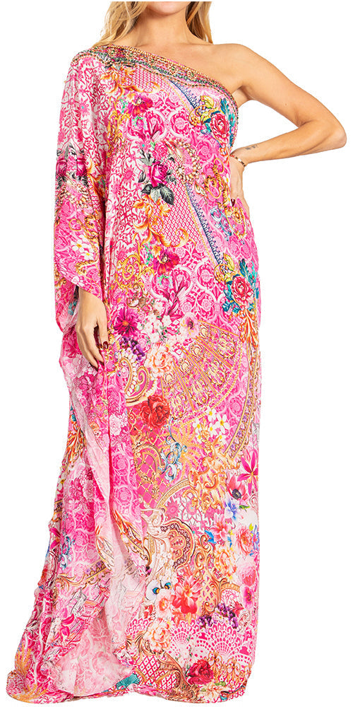 Woman wearing a colorful one-shoulder dress with floral patterns on a white background