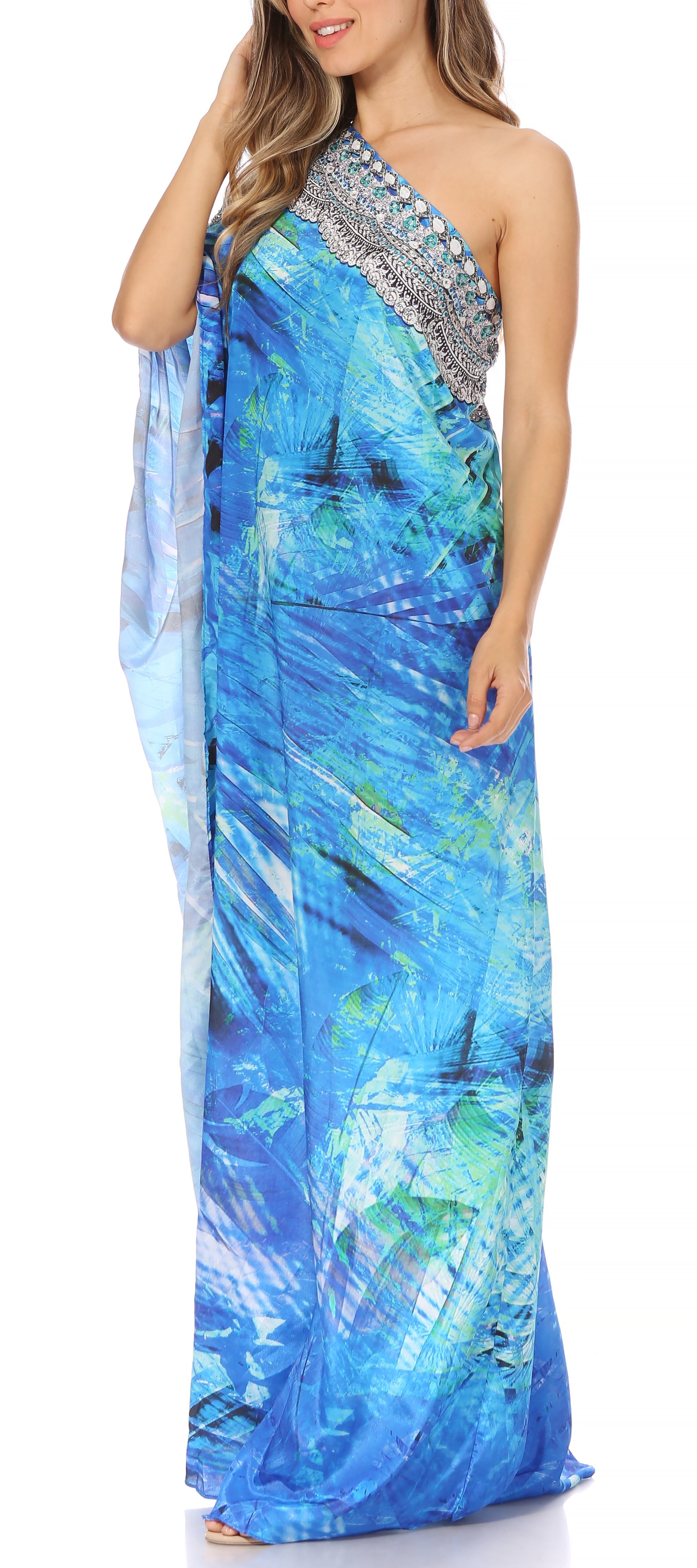 Woman wearing a blue and green patterned one-shoulder dress with a silver embellished neckline.
