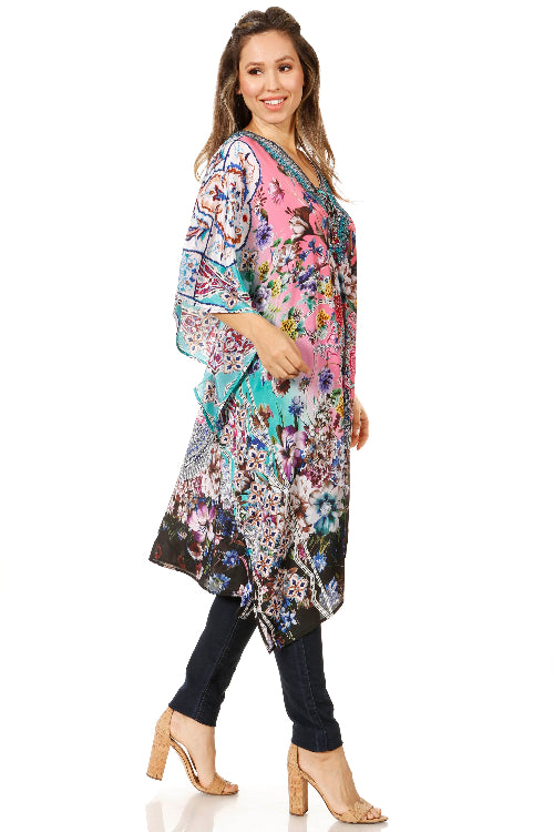 Woman wearing a colorful floral dress on a white background