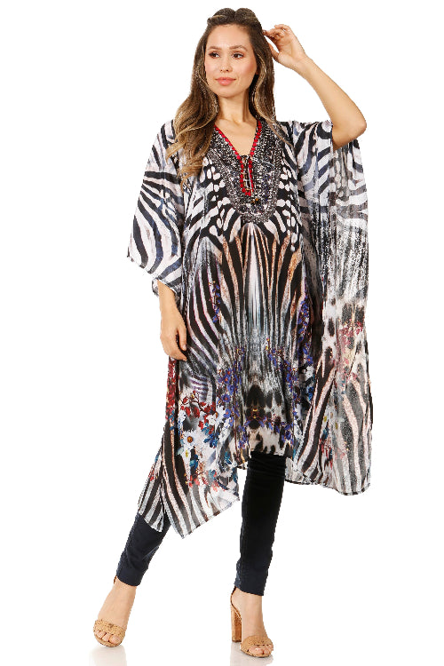 Woman wearing a long, patterned dress with zebra and floral designs on a white background