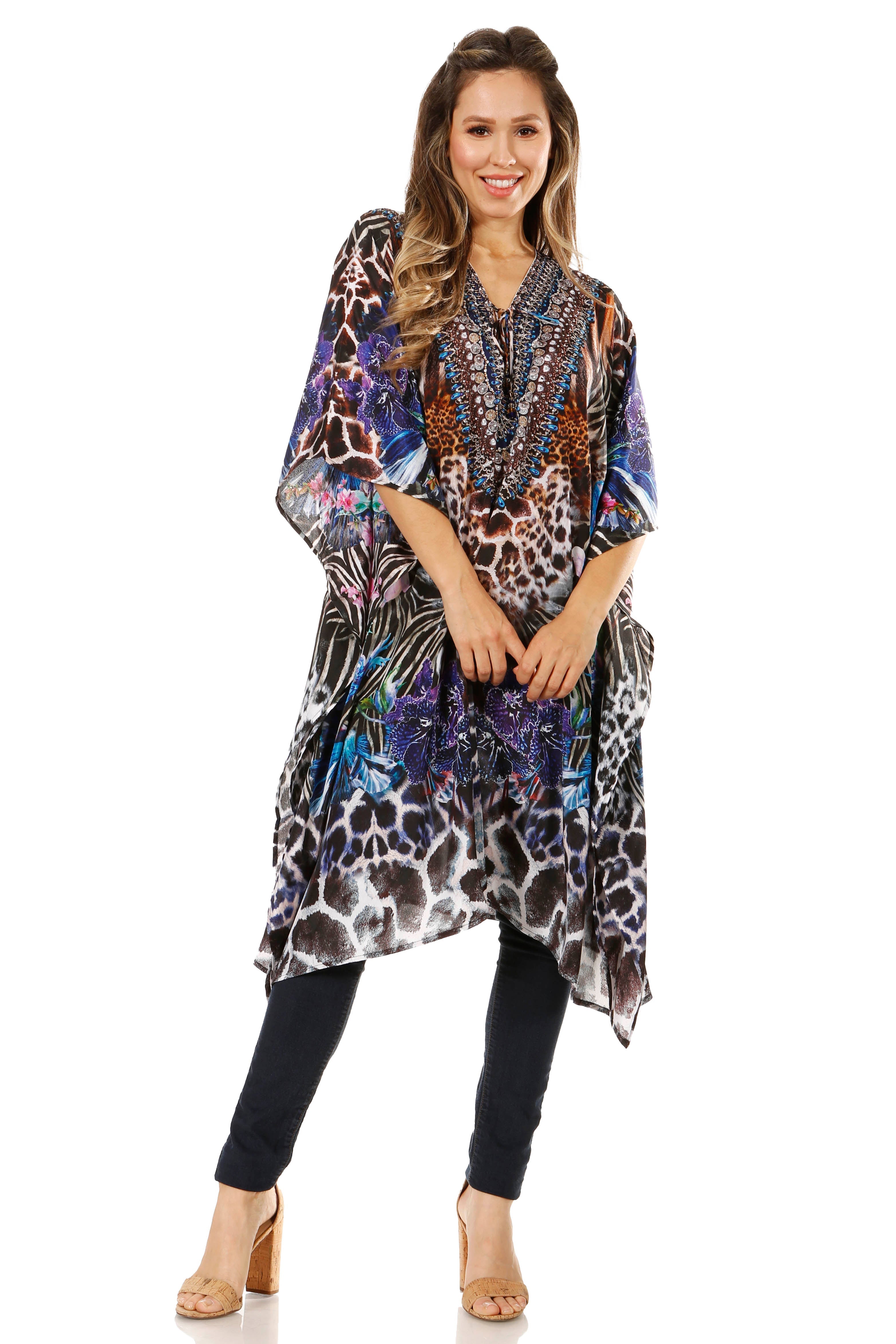 Woman wearing a colorful patterned dress over a black top and pants on a white background