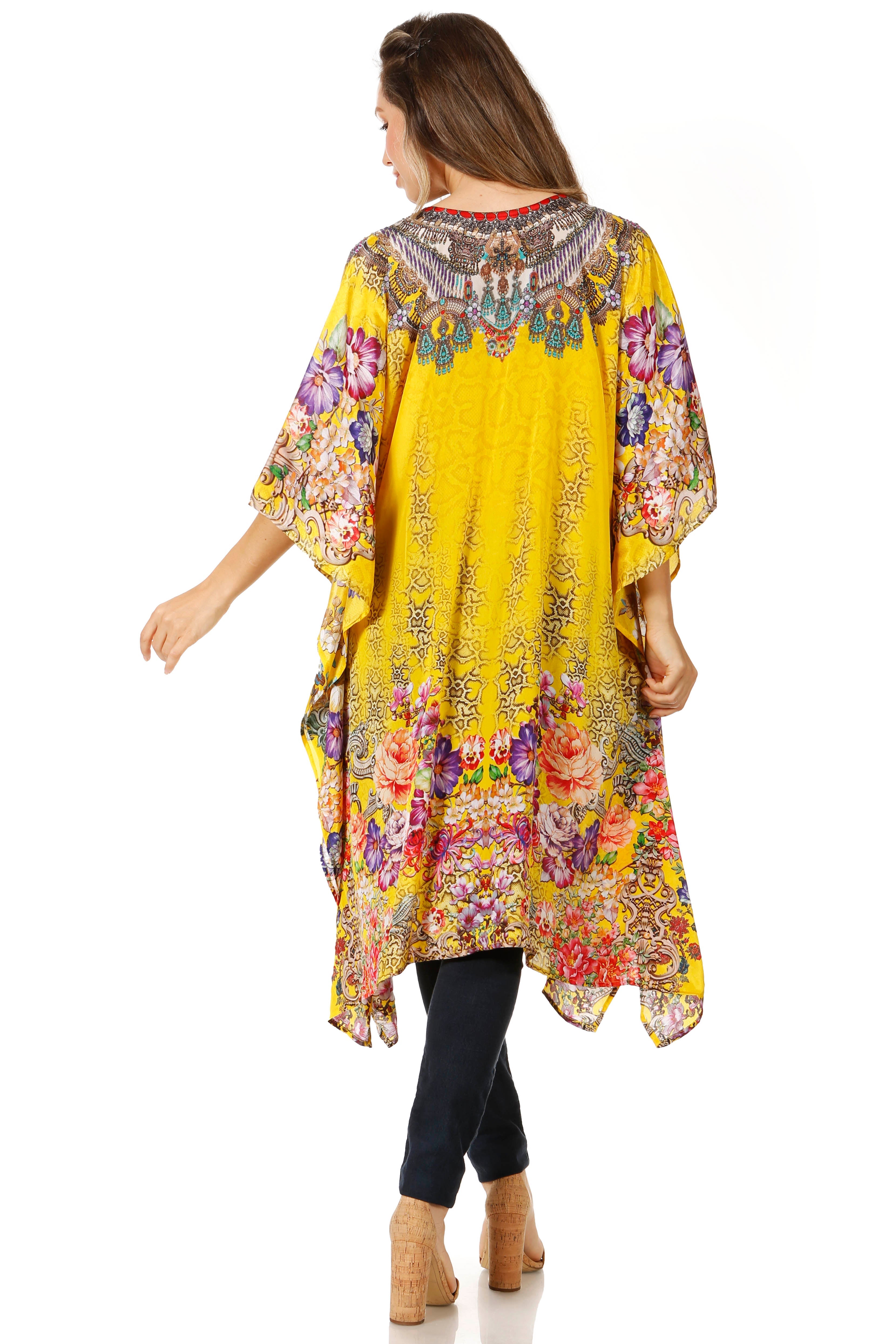 Woman wearing a colorful floral dress with a yellow base on a white background