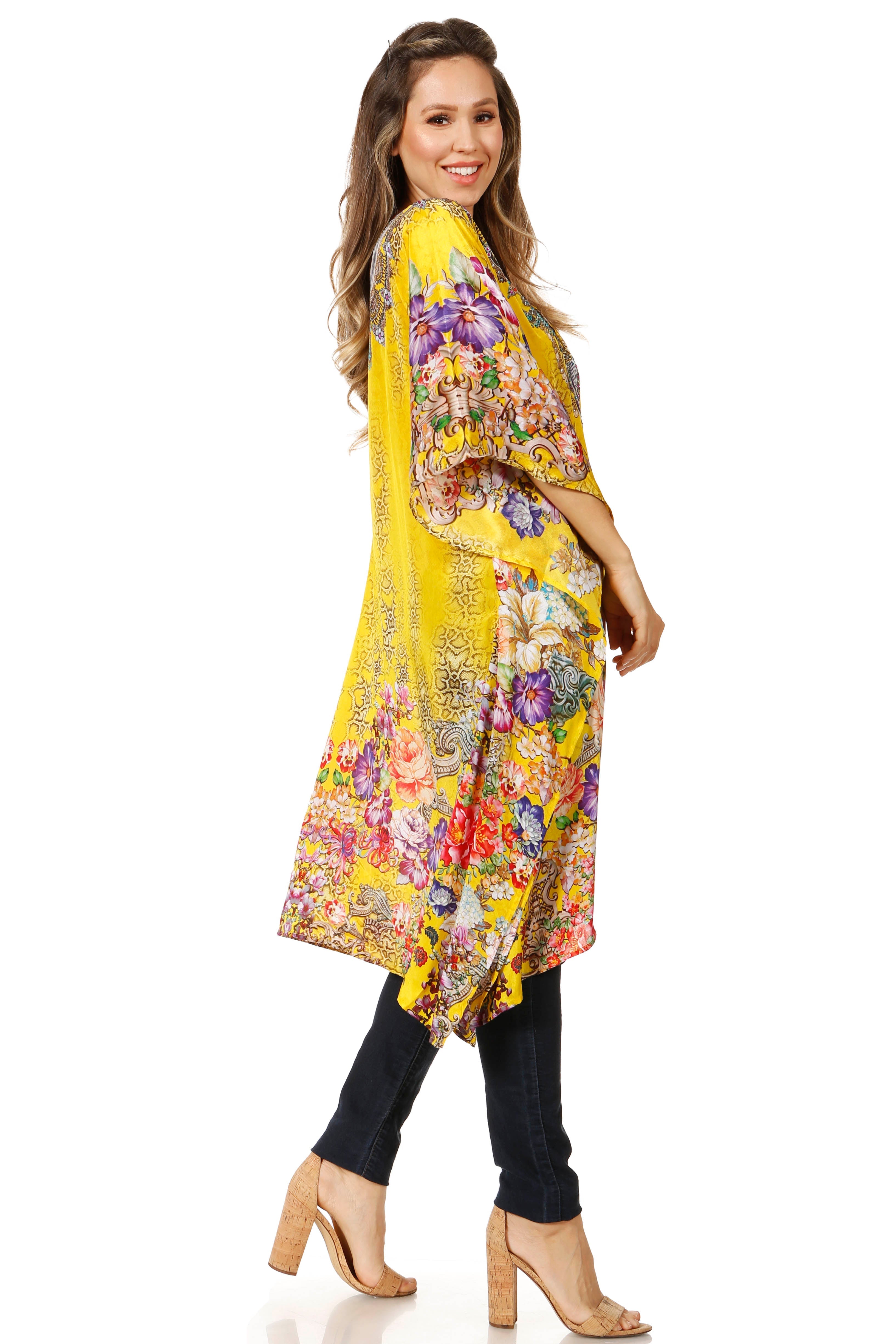 Woman wearing a yellow floral kimono on a white background