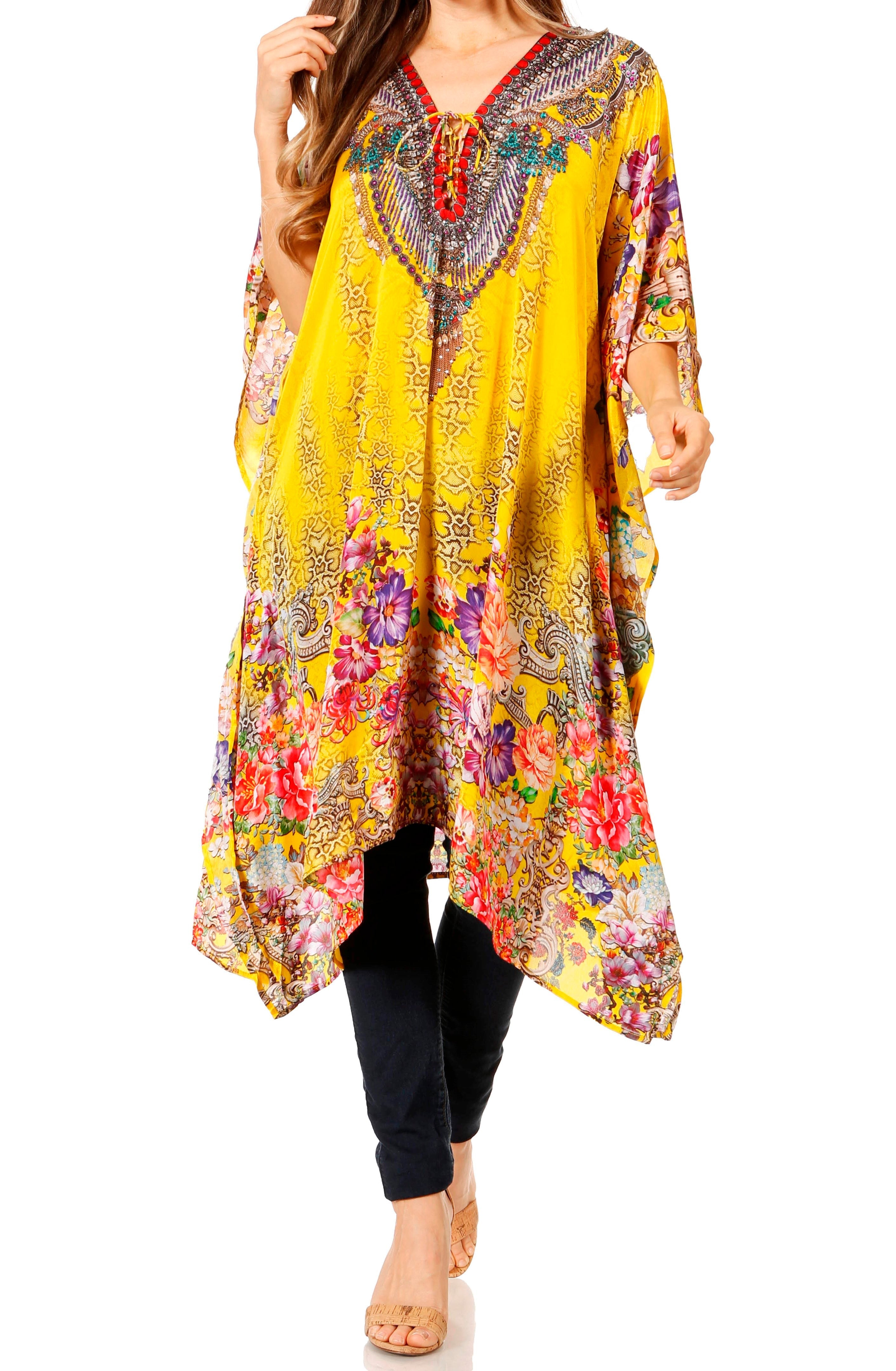 Woman wearing a colorful, patterned yellow dress with a white background