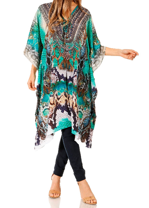 Woman wearing a colorful patterned dress over a black top and pants on a white background