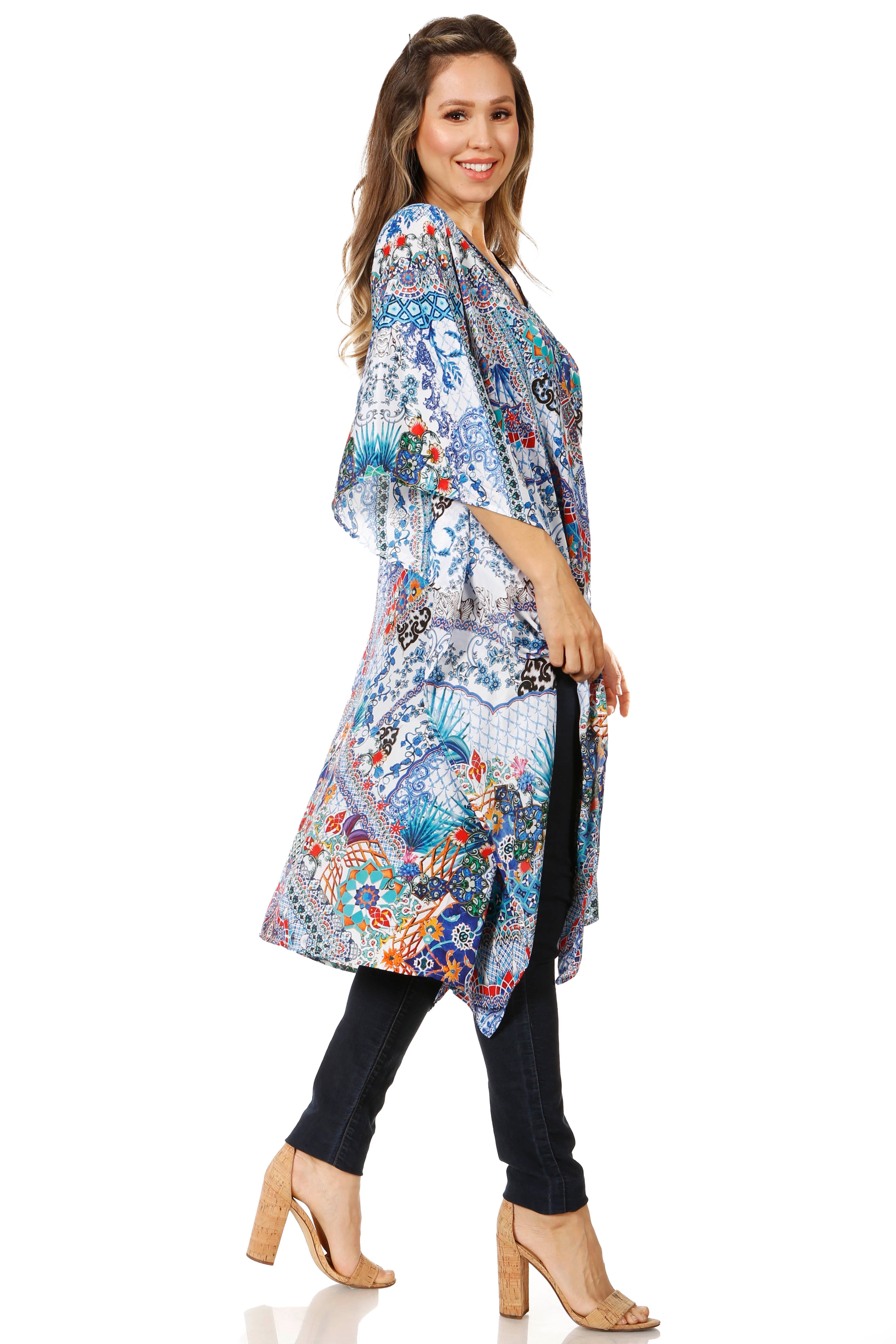 Woman wearing a colorful floral kimono-style top on a white background