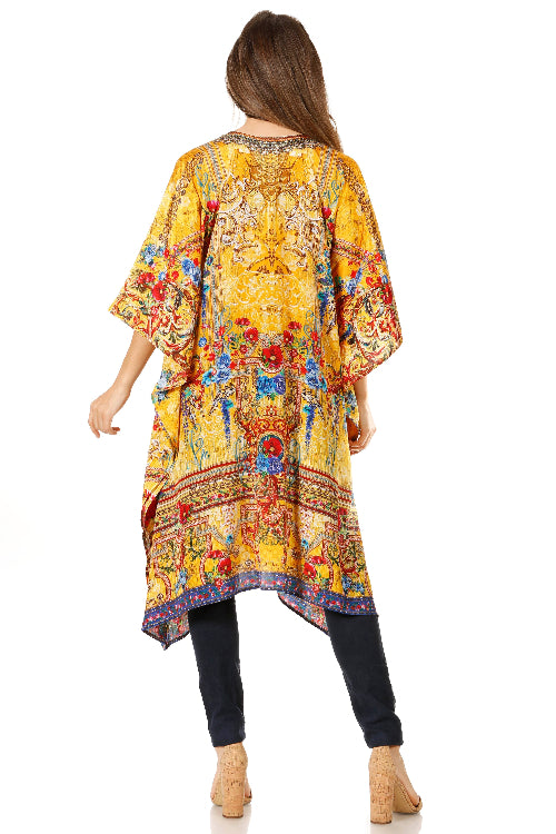 Woman wearing a colorful, patterned yellow dress with a white background
