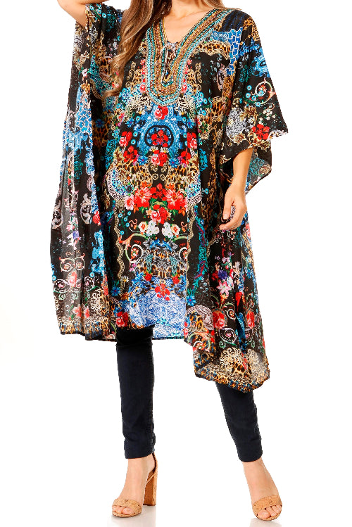 Woman wearing a colorful floral and paisley patterned dress with black pants on a white background
