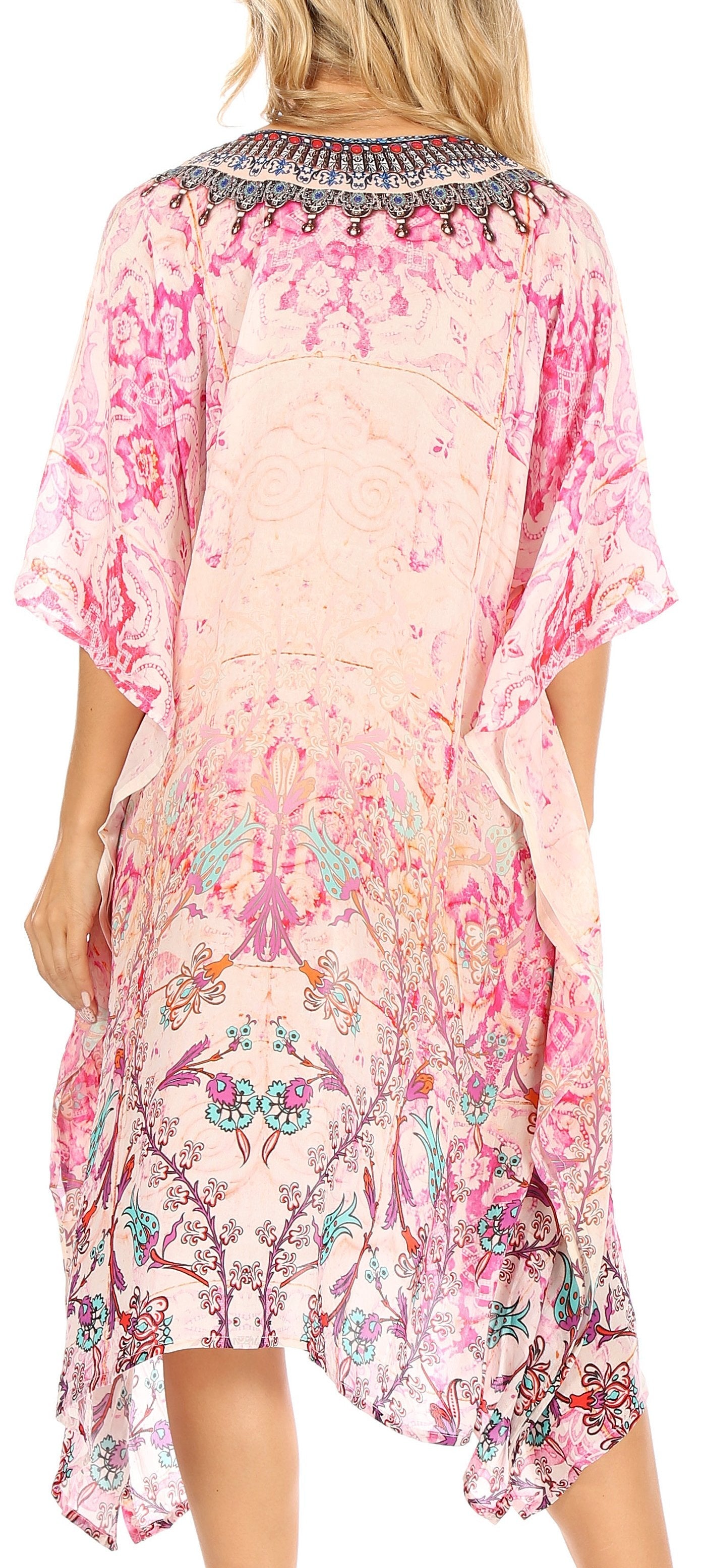Woman wearing a pink floral dress with a decorative neckline.