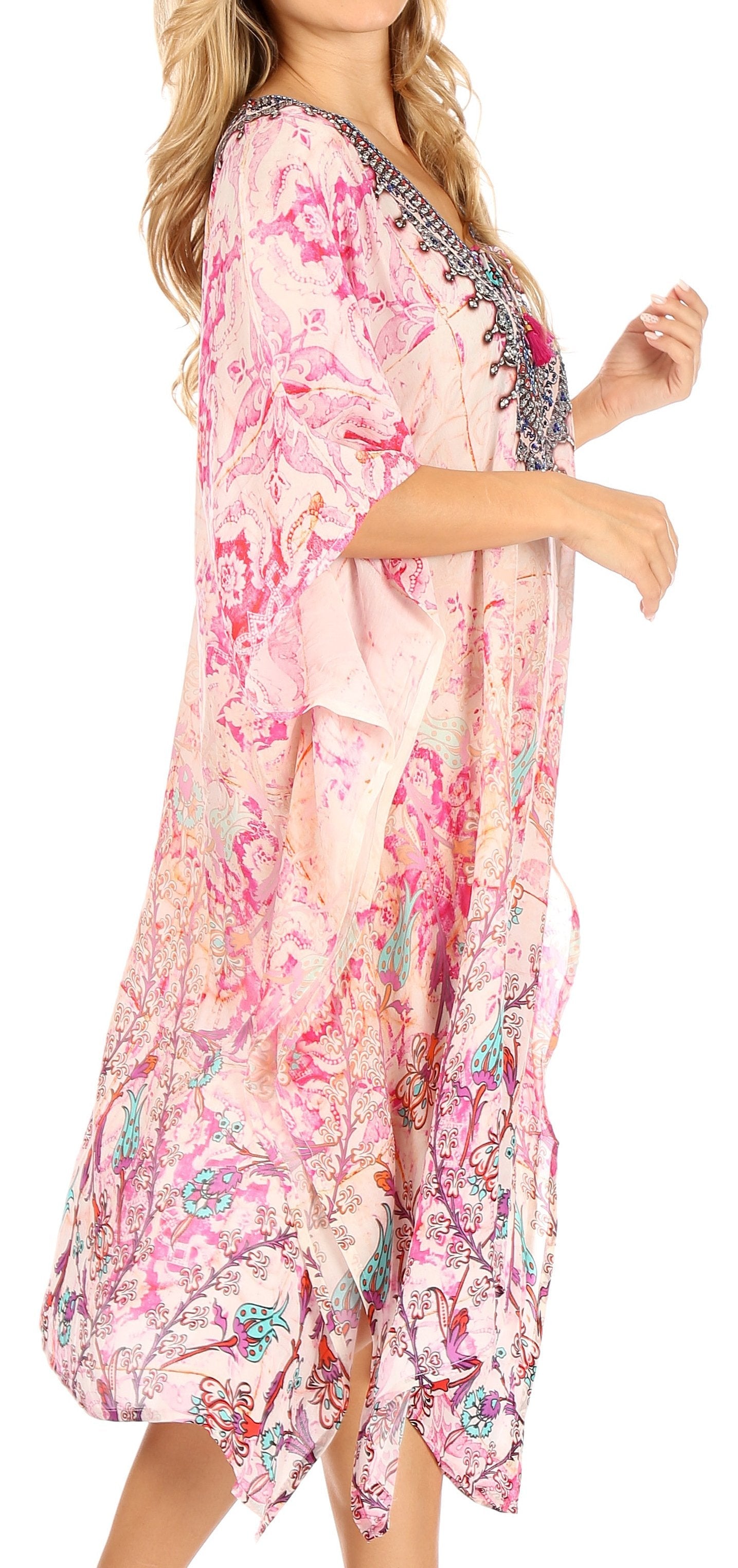 Woman wearing a floral dress with intricate patterns on a white background