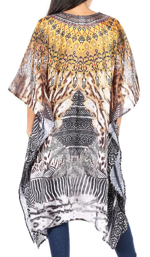 Woman wearing a patterned kaftan with abstract designs on a plain background
