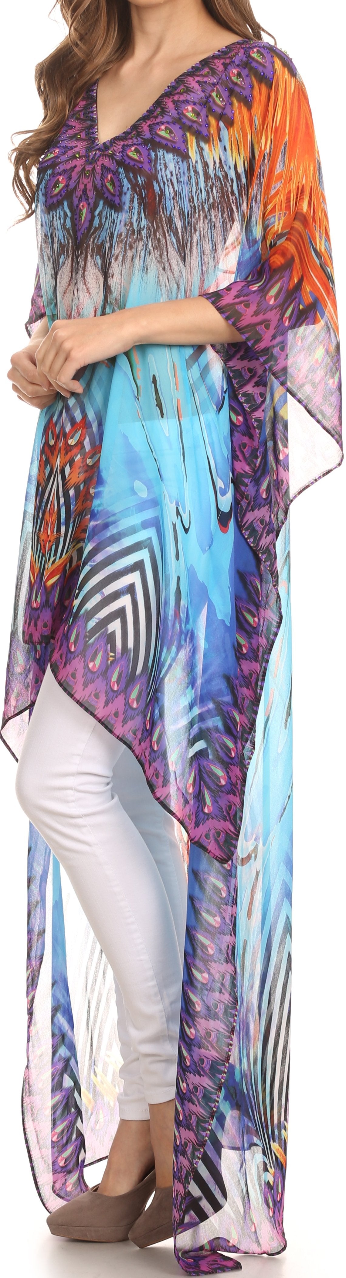 Woman wearing a colorful patterned dress with white pants.