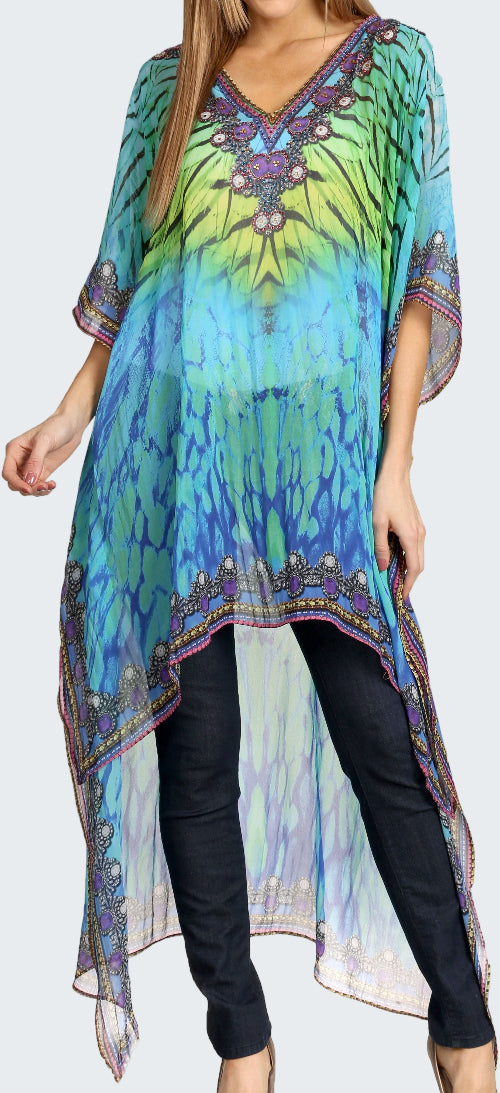Woman wearing a colorful tie-dye dress with a patterned top and black leggings.
