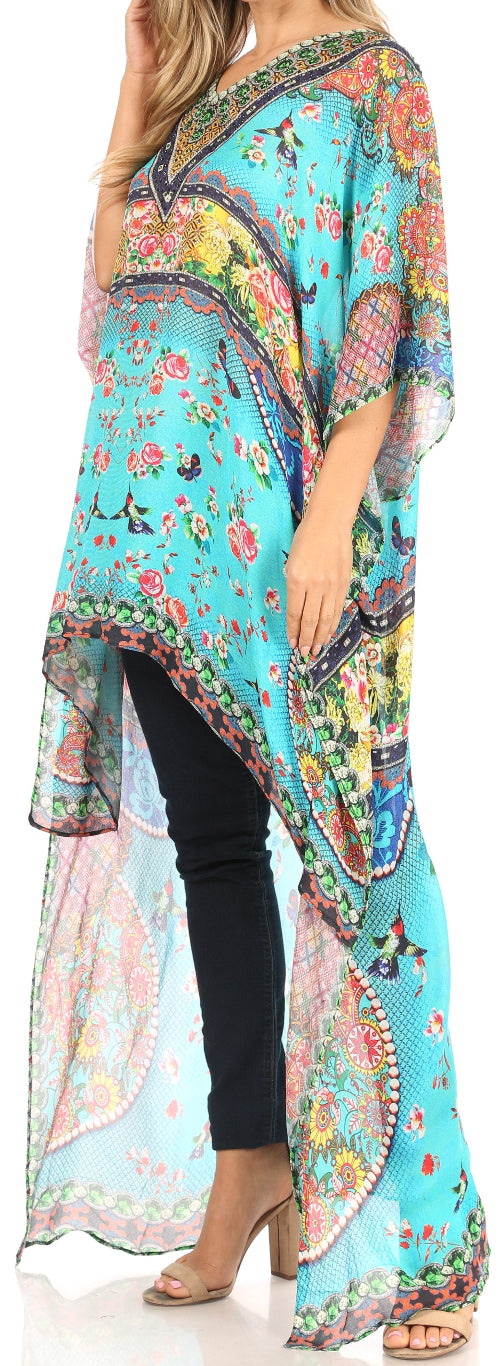 Woman wearing a colorful floral kimono-style garment with black pants on a white background