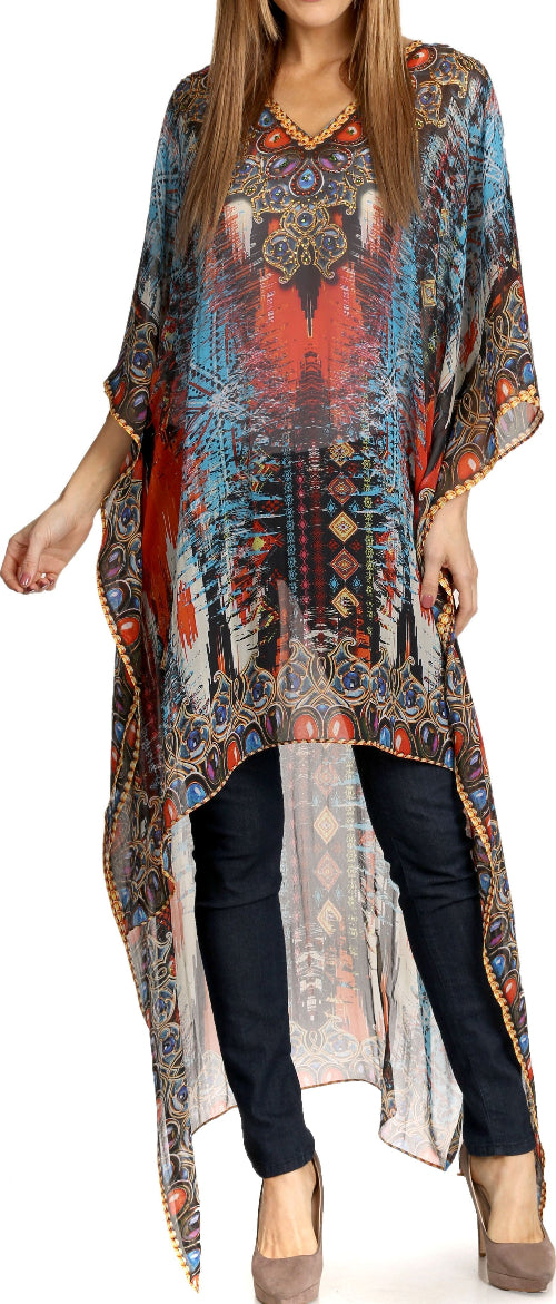 Woman wearing a long, patterned dress over dark pants on a white background