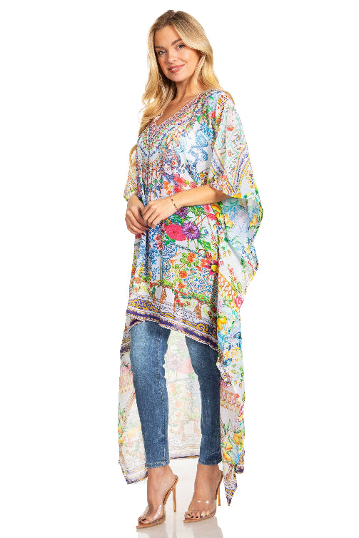 Woman wearing a colorful floral dress over jeans on a white background