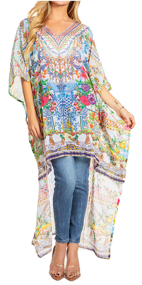 Woman wearing a colorful patterned kaftan over jeans on a white background