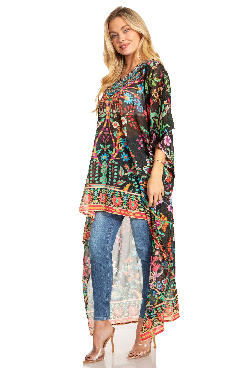 Woman wearing a colorful floral dress over jeans on a white background