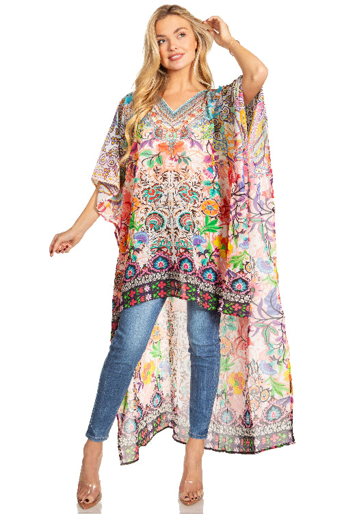 Woman wearing a colorful patterned dress over jeans on a white background