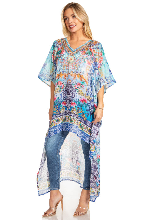 Woman wearing a colorful patterned dress over jeans on a white background