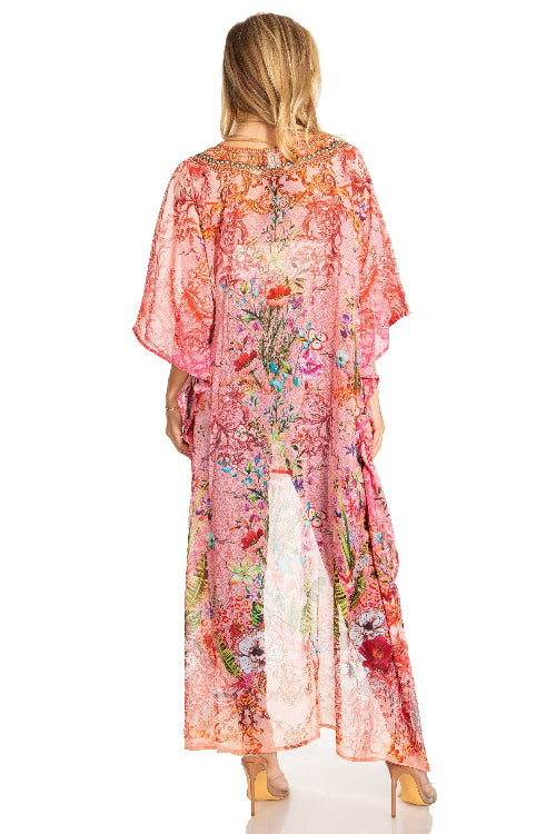Woman wearing a floral pink kimono-style garment on a white background
