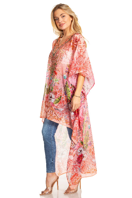 Woman wearing a colorful floral kimono over a blue dress on a white background