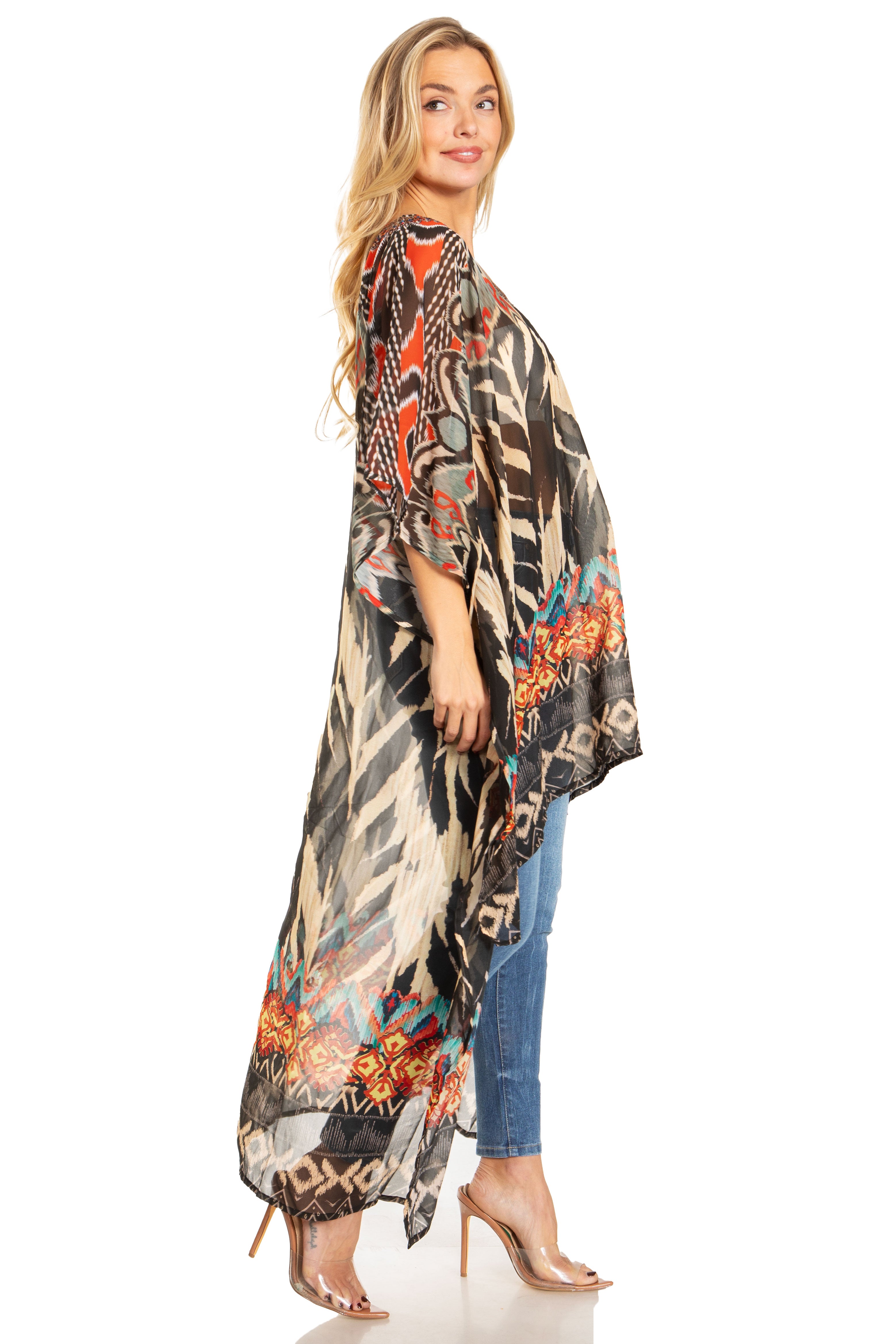 Woman wearing a long, patterned kimono over jeans on a white background