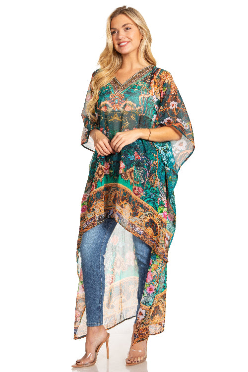 Woman wearing a colorful patterned dress over jeans on a white background