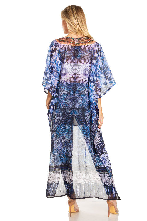 Woman wearing a blue and white patterned dress with sheer overlay on a white background