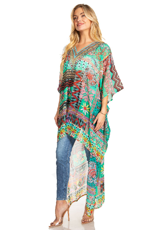 Woman wearing a colorful patterned dress over jeans on a white background