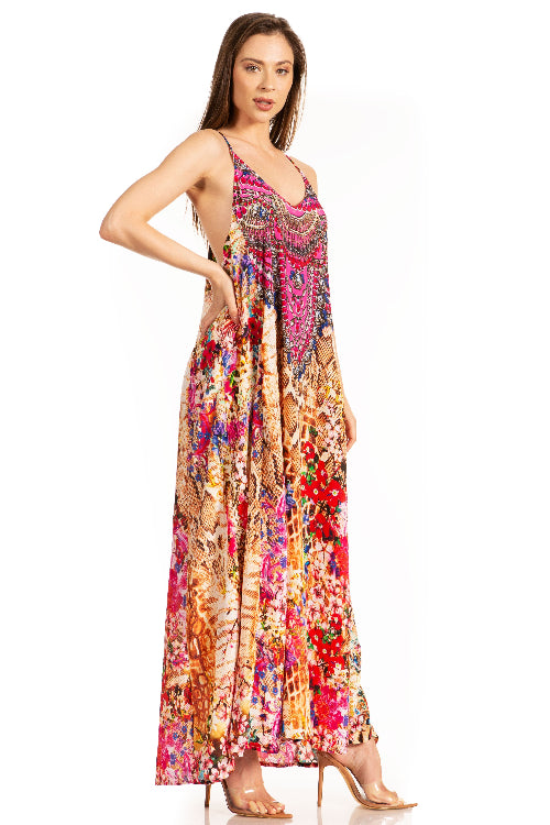 Woman wearing a colorful floral dress on a white background