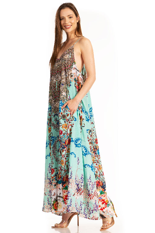 Woman wearing a colorful floral dress on a white background