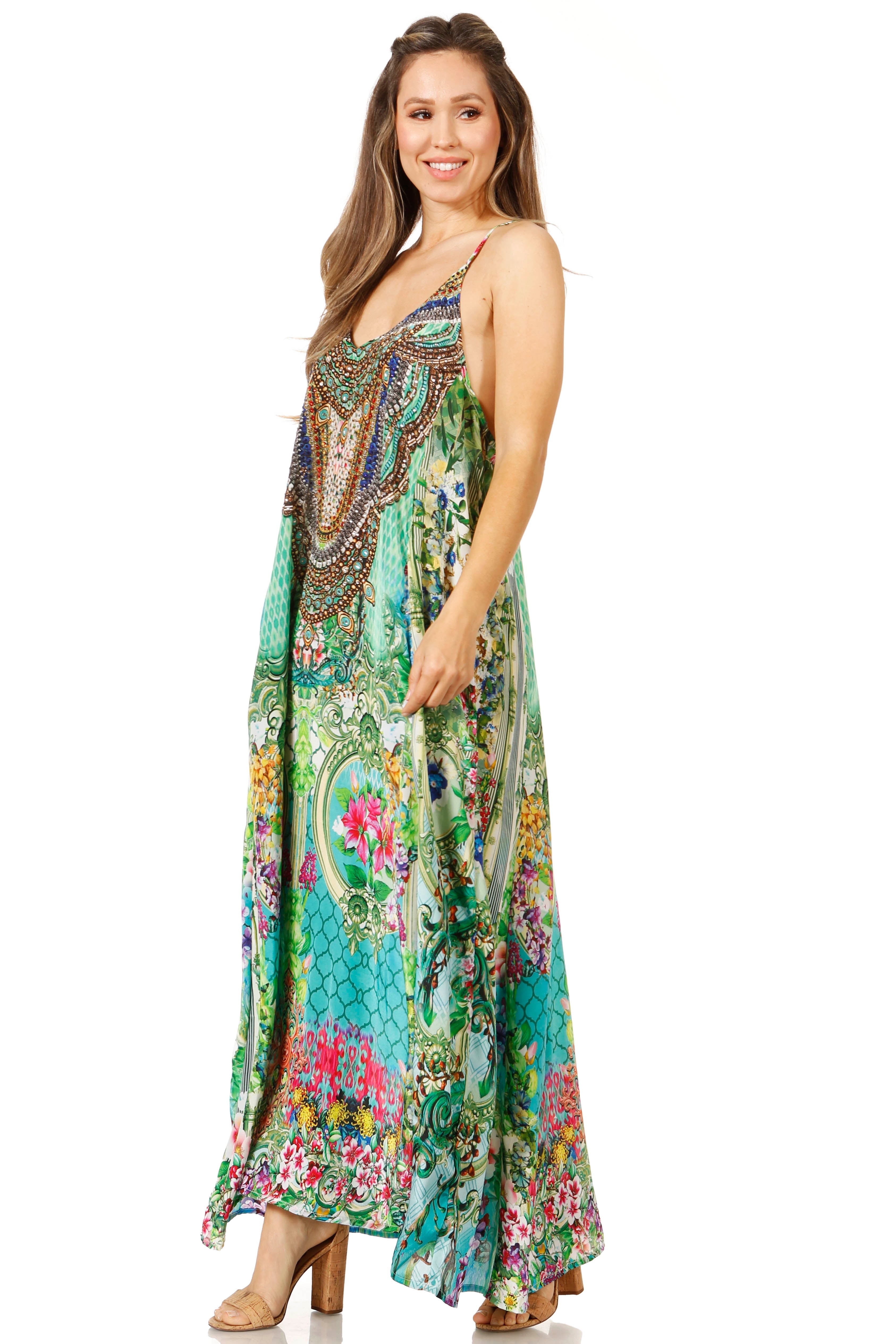 Woman wearing a colorful floral and paisley patterned dress on a white background