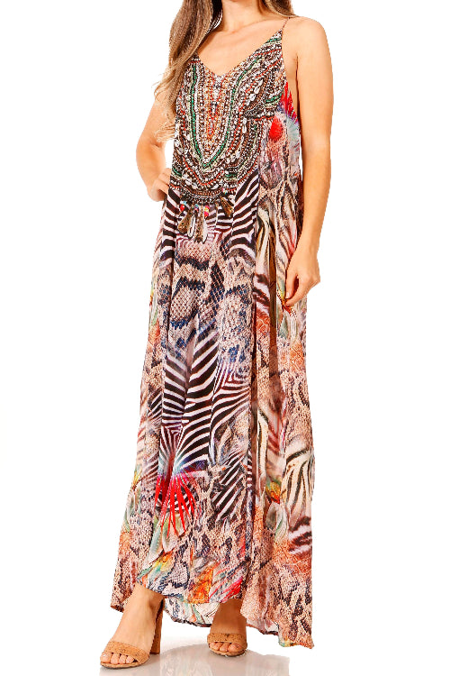 Woman wearing a colorful patterned maxi dress on a white background