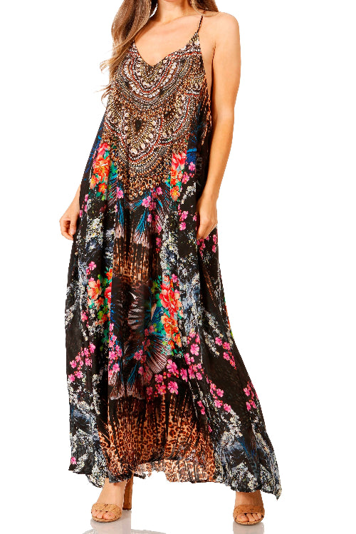 Woman wearing a long, patterned dress with floral and abstract designs on a white background