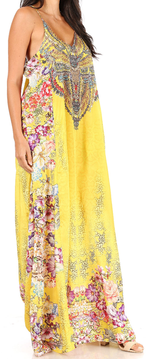 Woman wearing a yellow floral maxi dress with intricate patterns.