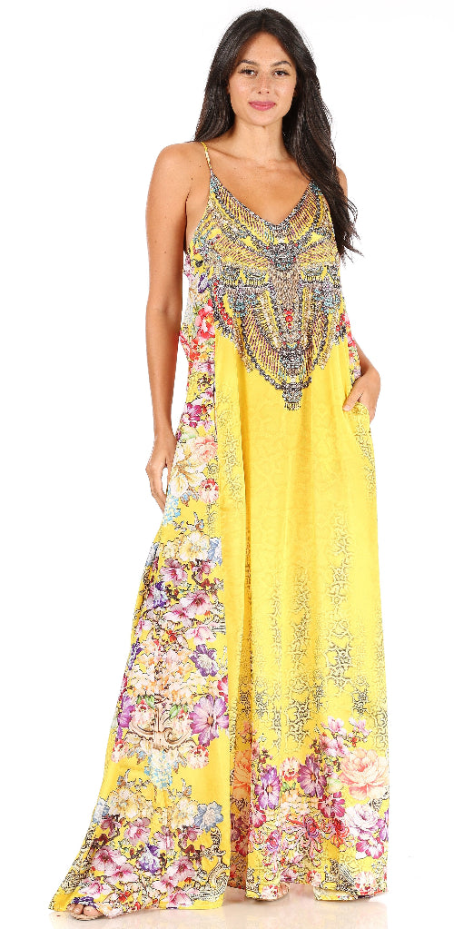 Woman wearing a yellow floral dress with intricate patterns