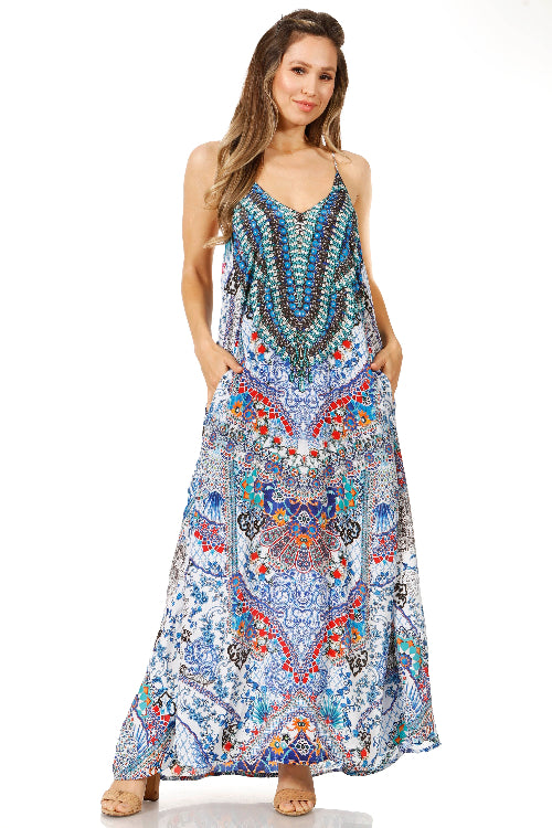 Woman wearing a colorful patterned maxi dress on a white background