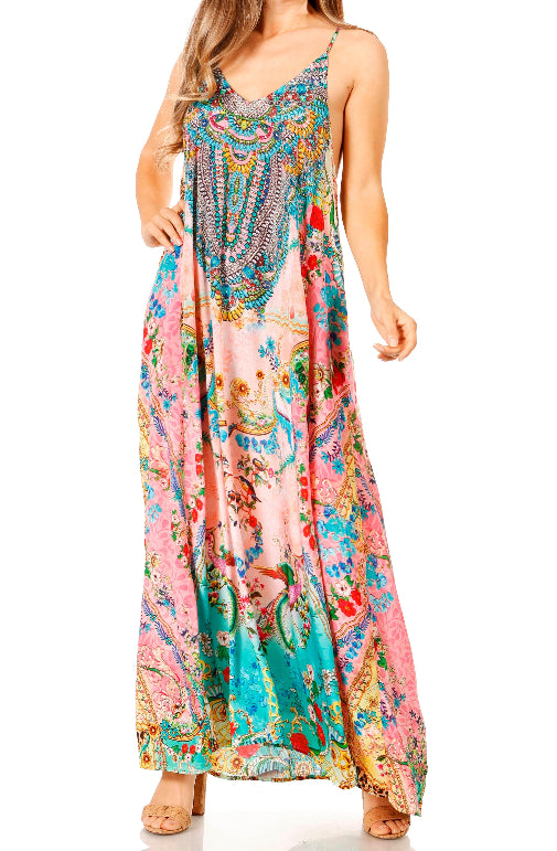 Woman wearing a colorful patterned maxi dress on a white background