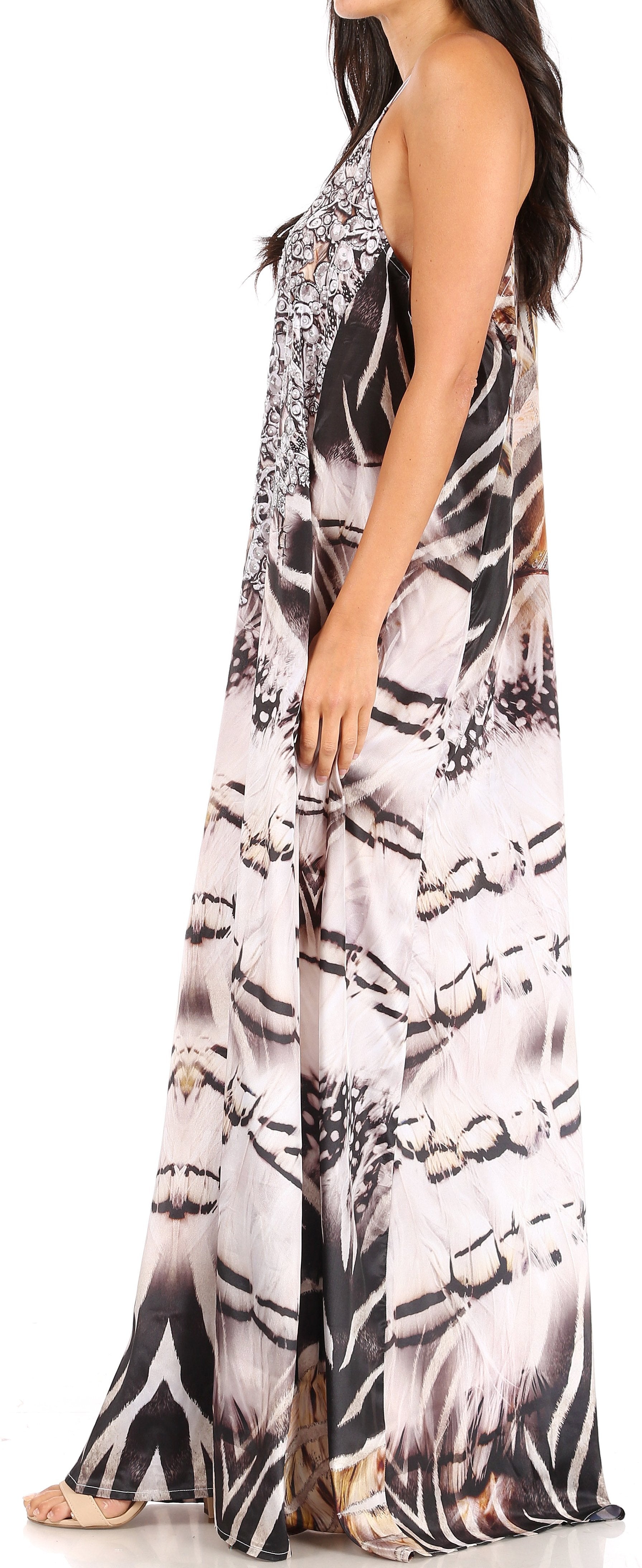 Woman wearing a sleeveless, long dress with a black and white pattern.