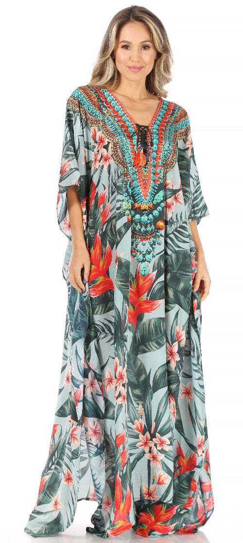 Woman wearing a colorful floral dress with a palm leaf pattern.