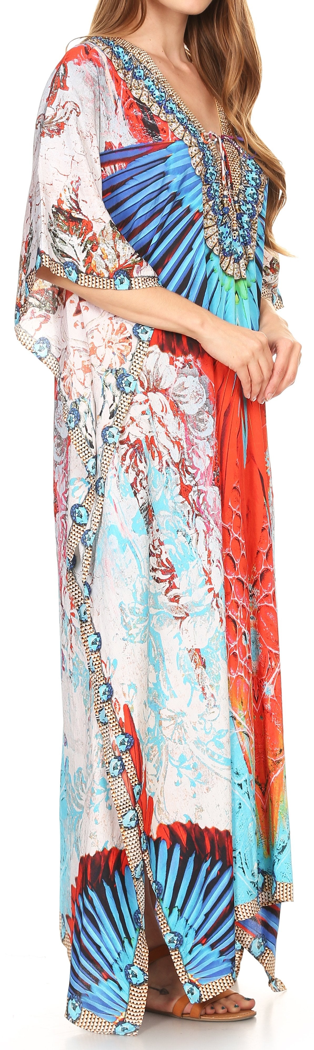 Woman wearing a colorful patterned dress with sheer sleeves.