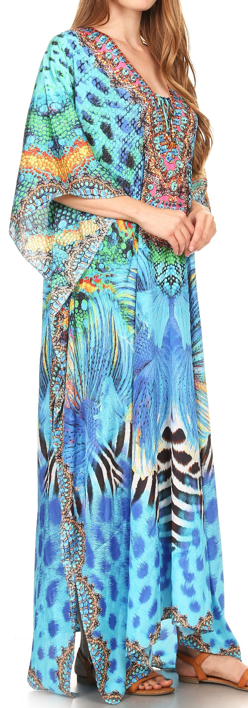 Woman wearing a colorful patterned dress with a blue and green design.