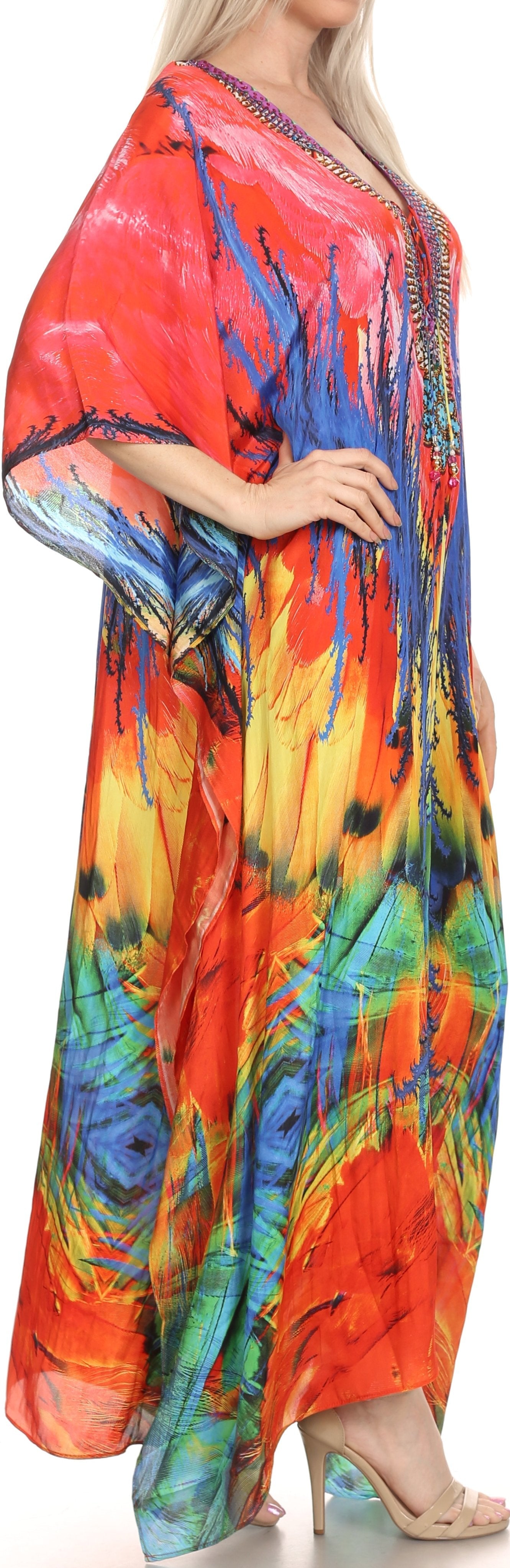 Colorful dress with peacock feather design worn by a model.