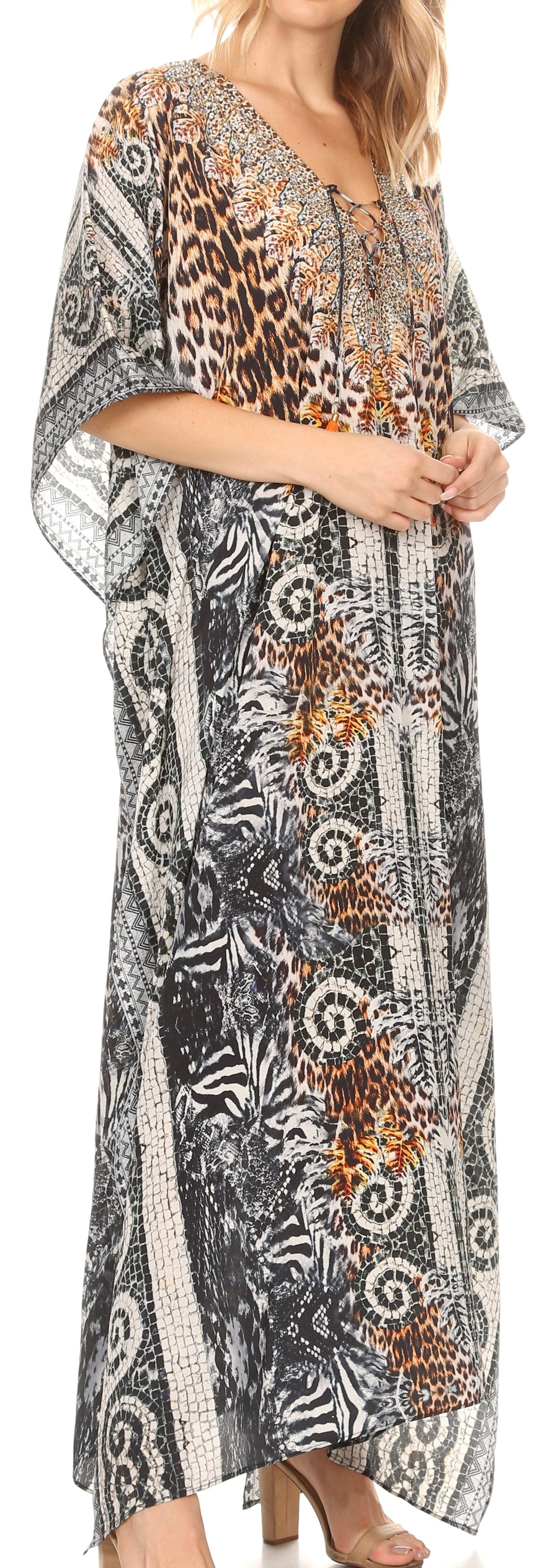 Woman wearing a long, patterned dress with a mix of floral and abstract designs.
