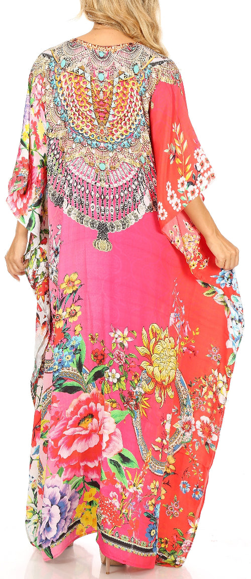 Woman wearing a colorful floral and geometric patterned dress with a bright pink base.