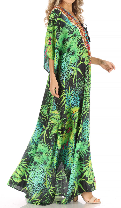 Woman wearing a long, colorful dress with a tropical leaf pattern on a white background