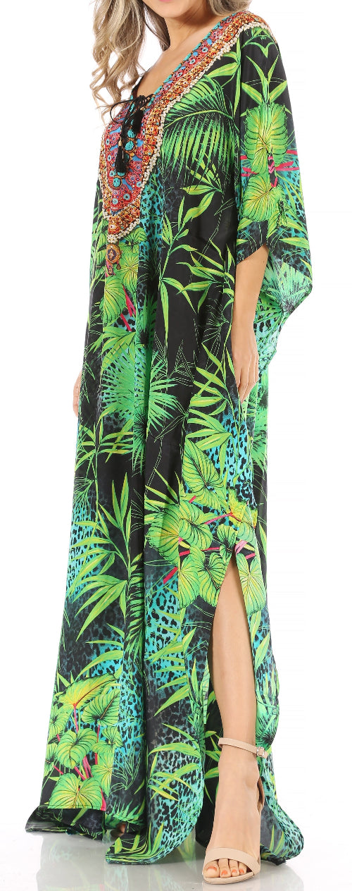 Woman wearing a colorful tropical print dress with a slit.